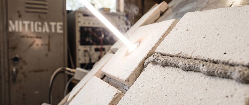 Laser beam material testing refractory tiles under high temperature thermal stress in science laboratory engineering facility research development mitigation experiment industrial setup aerospace tech