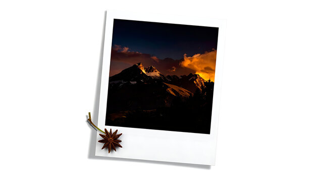Isolated vintage polaroid frame containing a dramatic golden hour mountain landscape with a metallic mace icon overlay