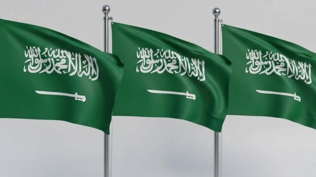 Three saudi arabia flags waving on flagpoles