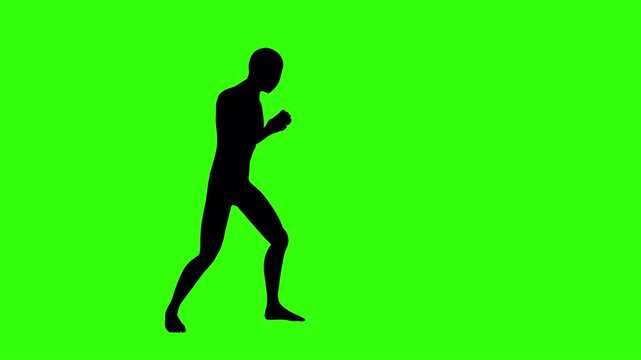 Silhouette of a male boxer practicing punches on a green screen.