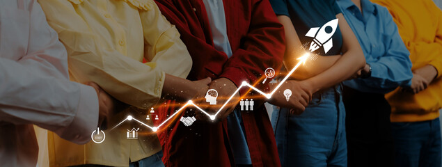 A diverse group of individuals stands united, embodying teamwork and motivation, as a graphic of a rocket symbolizes growth and success in any venture. Trope © InfiniteFlow