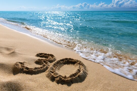 Number 30 written in sand on a sunny beach with gentle ocean waves approaching under a bright blue sky with scattered clouds and sparkling water light reflections