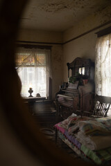 Vintage house interior with antique wooden furniture, old piano, retro armchair and lace curtains on window, nostalgic abandoned or historic room © Iryna
