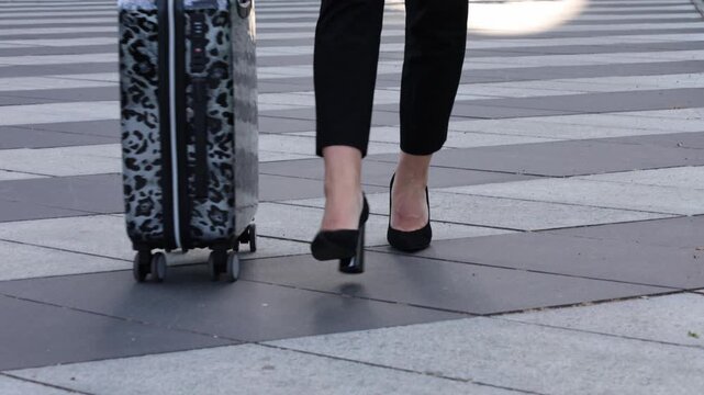 Traveling through the city with a suitcase at a busy plaza on a sunny day