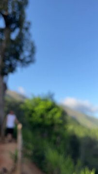 Blurred nature background with person hiking down mountain trail