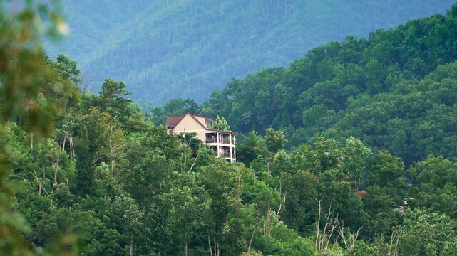 Scenic mountain homes in the Appalachian region of Tennessee with lush woodland, rolling hills and tranquil summer landscape