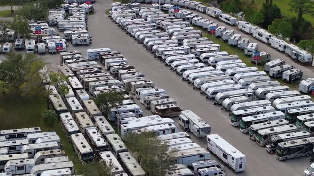 New camping trailers parked for sale on RV dealer parking lot in Ft. Myers, Florida.