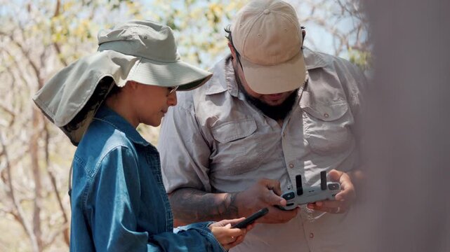 Park rangers operating drone for conservation efforts