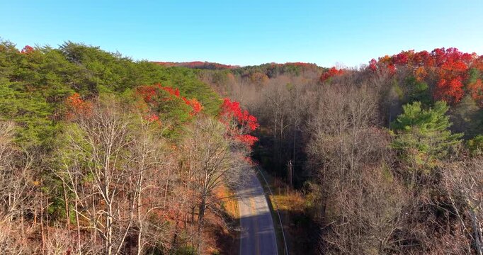 Blue Ridge Parkway in autumn. Mountain pass road between dense woods in seasonal colors in North Carolina.
