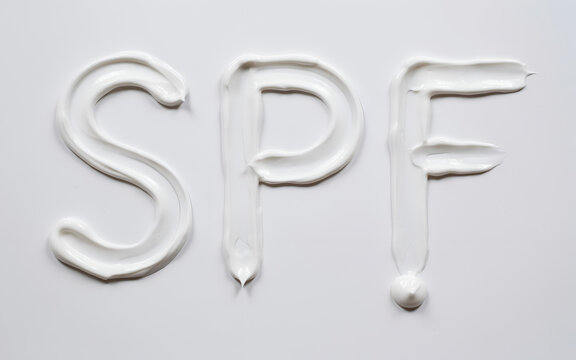 Sunscreen cream forming SPF letters with soft lighting and selective focus
