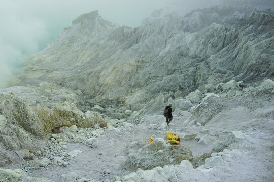 Solo Female Hiker in the Dramatic Landscape of Kawah Ijen, Indonesia.