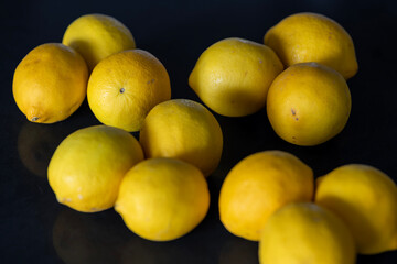 Fresh Yellow Lemons on Dark Surface with Selective Focus © Inna