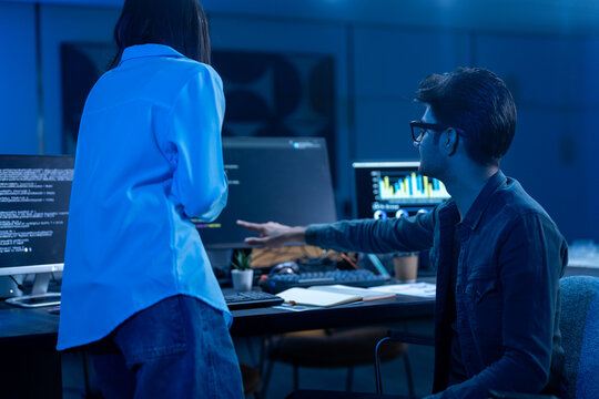 Coding team, Professional IT specialist and programmer working on software development, Male developer talking with female colleague about computer code, Modern and technology collaboration concept