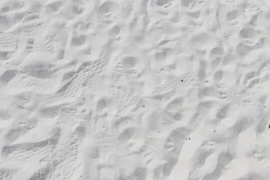 Fine white sand that glistens and reflects the sunlight.