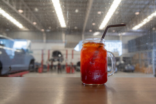 Iced Red Drink in Mason Jar with Straw, Iced black tea