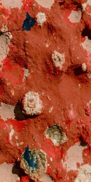 Natural terracotta clay texture with cochineal pigment and raw mineral rings, a porous weathered surface for Andean cultural background and packaging