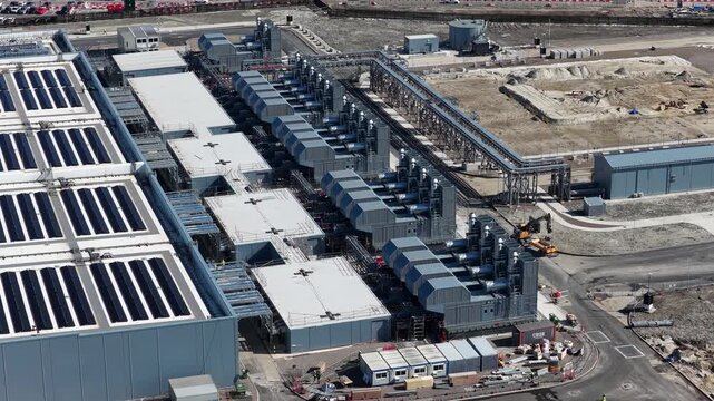 Aerial drone view of data center backup generators, diesel units, fuel tanks, switchgear and critical power systems.