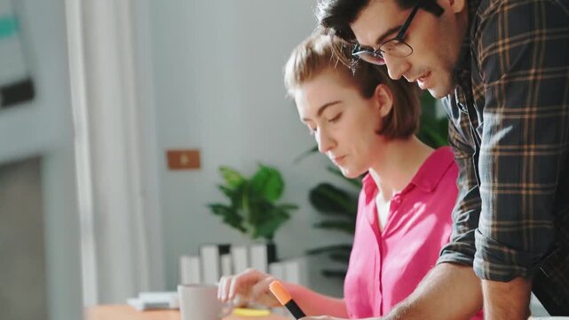Smart project manager working together with businessman choosing logo design. Professional business team planning and discussing about marketing strategy while looking at color palettes. Symposium.