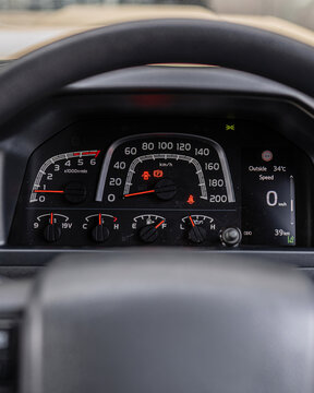 Close up car dashboard with speedometer tachometer gauges.