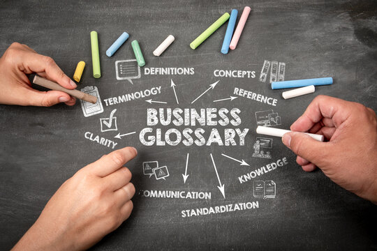 Business Glossary Concept With Hands Writing Key Terms on Chalkboard