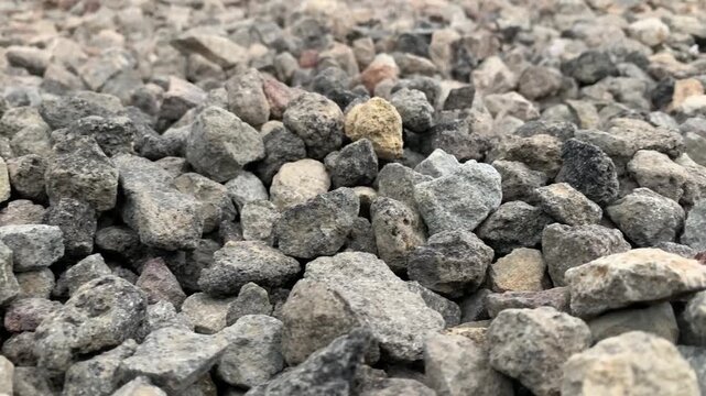 Close-up footage of crushed stones used as aggregate for construction, roadwork, drainage systems, and concrete production.