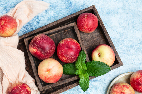 Fresh nectarine against a blue background