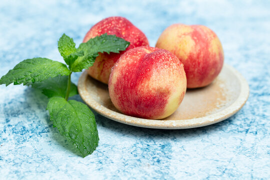 Fresh nectarine against a blue background