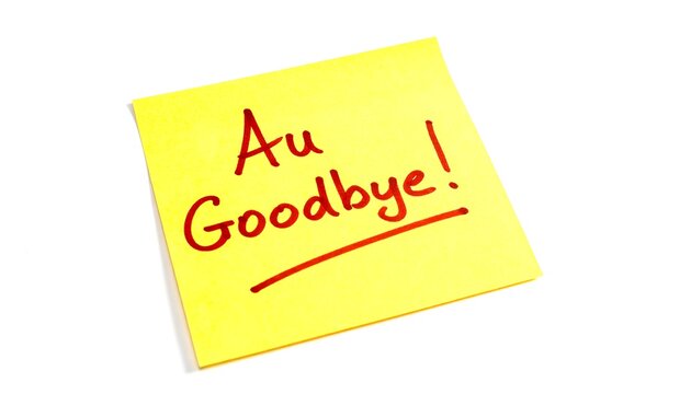 A square, yellow sticky note with red text that says, "Au Goodbye!" with a red line underneath the message. It's against white