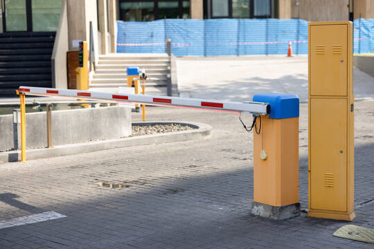 Security gate with barrier arm blocks entry
