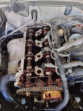 DOHC Engine with Valve Cover Removed Showing Camshaft and Timing Chain