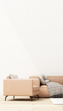 Warm minimalist living room featuring a tan leather armchair and sofa, soft cushions and grey throw on pale wood flooring.