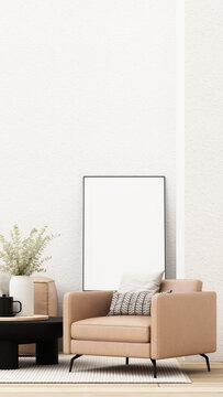 Cozy modern living room with a tan armchair, black coffee table, eucalyptus vase and blank framed wall art mockup.