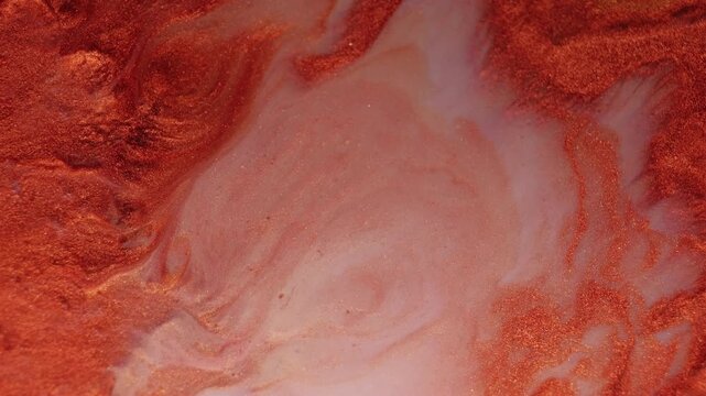 Glitter fluid. Art paint. Defocused orange bronze ink in water brick texture particles spilling on abstract marble milky background.