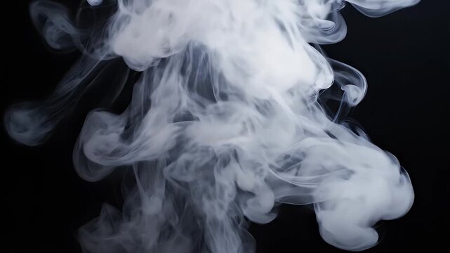 A swirling cloud of white smoke dramatically rises against a stark black background, creating a captivating visual contrast.