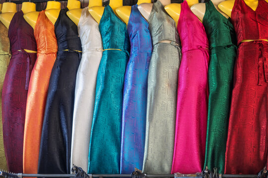Colorful textured silk halter neck dresses on mannequins