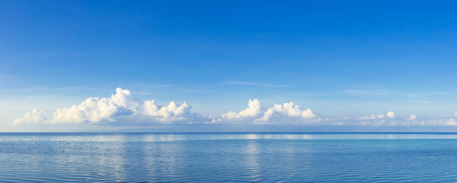 blue sky with clouds and a spacious ocean
