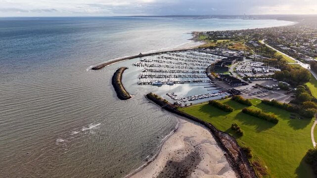 Aerial drone view of Egaa Marina breakwater extending into Aarhus Bay along the Danish coastline