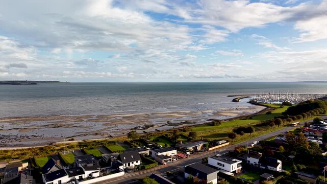 Aerial drone view of Egaa Marina and shoreline along Aarhus Bay under expansive coastal skies in Denmark