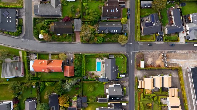 Top down aerial drone view of residential neighborhood and streets in Egaa Denmark showcasing urban planning patterns