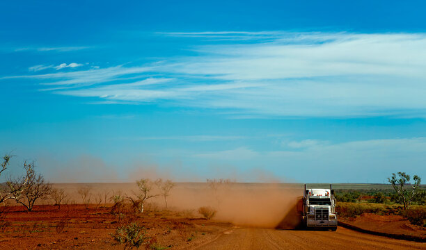 Road truck raising dust on remote outback road in Australia