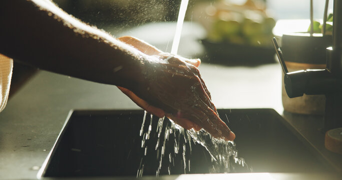 Basin, washing hands and water with person in kitchen of home for cleaning or personal hygiene. Health, skincare and wellness routine with man at sink in apartment to remove bacteria, dirt or germs