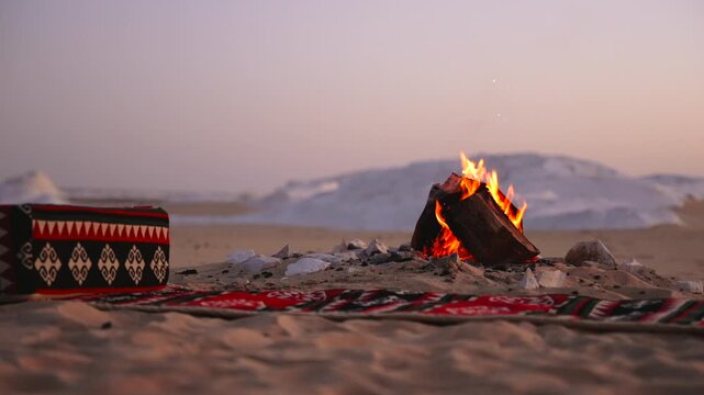 Traditional Bedouin Camp with Bonfire and Ethnic Rug at Twilight in Egyptian Desert