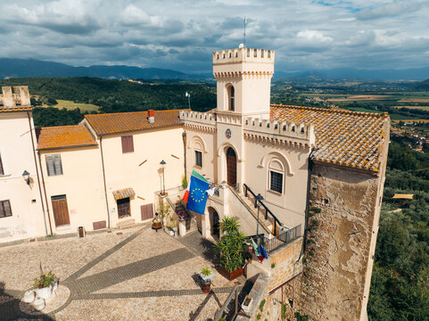 Aerial view of the historic Orsini Castle with its prominent tower and courtyard overlooking the lush Tiber Valley in Stimigliano, Lazio, Italy.