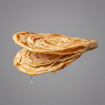 Side View of Layered Lachha Paratha Flatbread Pulling Apart. Has copy space for text.