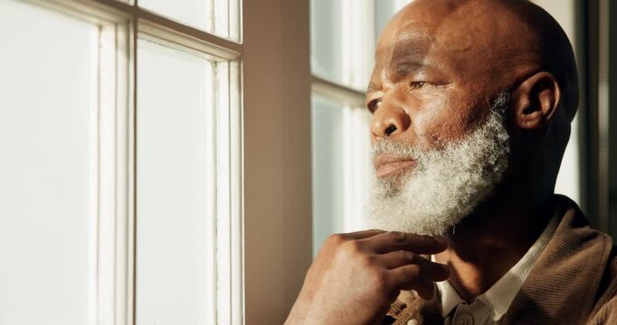 Black man, senior and thinking by window in home, contemplating or ponder with serious contemplation. Person, retired or perspective, nostalgia or remember with memory, insight or reflection at house