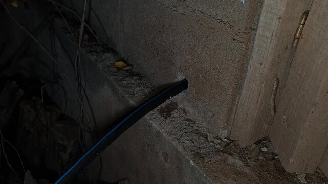 Inserting Water Hose inside Concrete Block Wall Hole