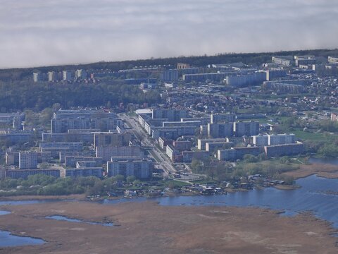 Aerial view of Liepaja Lake and the surrounding urban residential area with apartment blocks and green spaces in Liepaja, Latvia.
