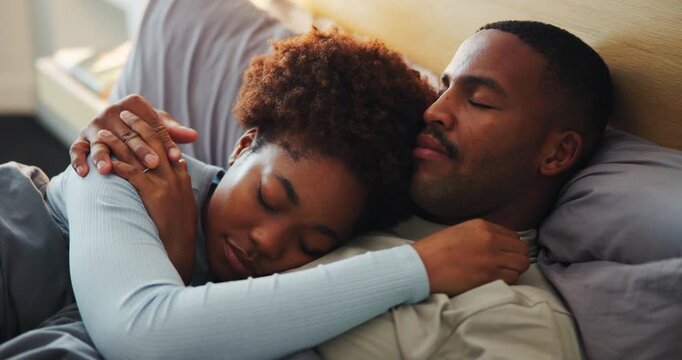 Couple, sleeping and cuddle on bed, home and bonding with partner in bedroom, support and connection. Black people, love and resting with spouse in house, affection and commitment for relationship