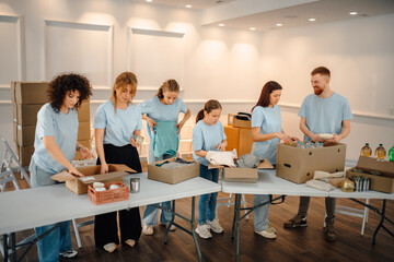 Volunteers packing donation boxes for humanitarian aid