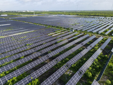 Aerial view of San Ignacio solar photovoltaic power plant with rows of solar panels extending across the landscape in Progreso, Yucatan, Mexico.